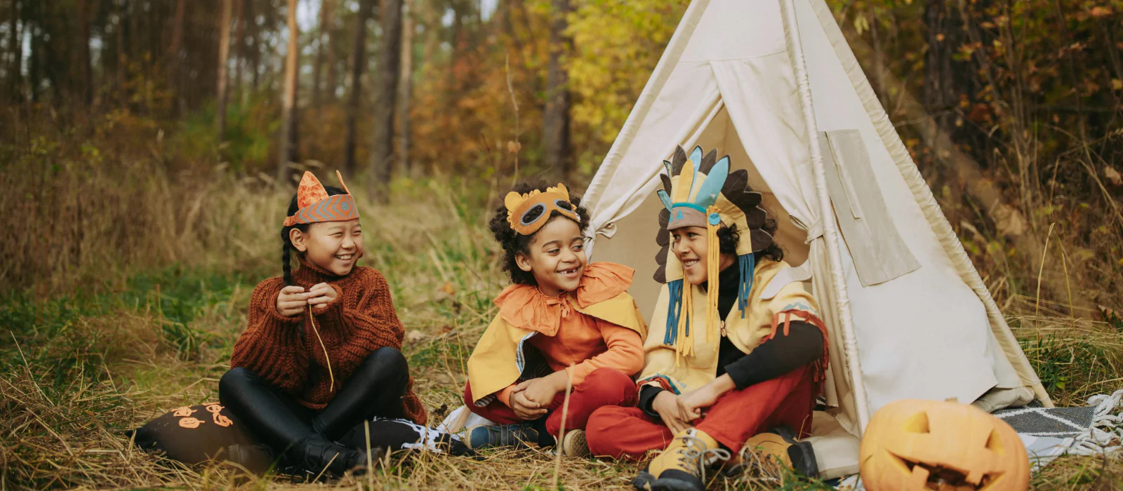 children enjoying halloween camping party and wearing costumes