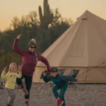 family enjoying camping with canvas tent