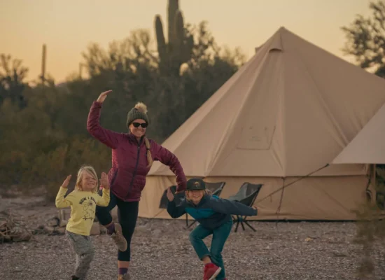 family enjoying camping with canvas tent