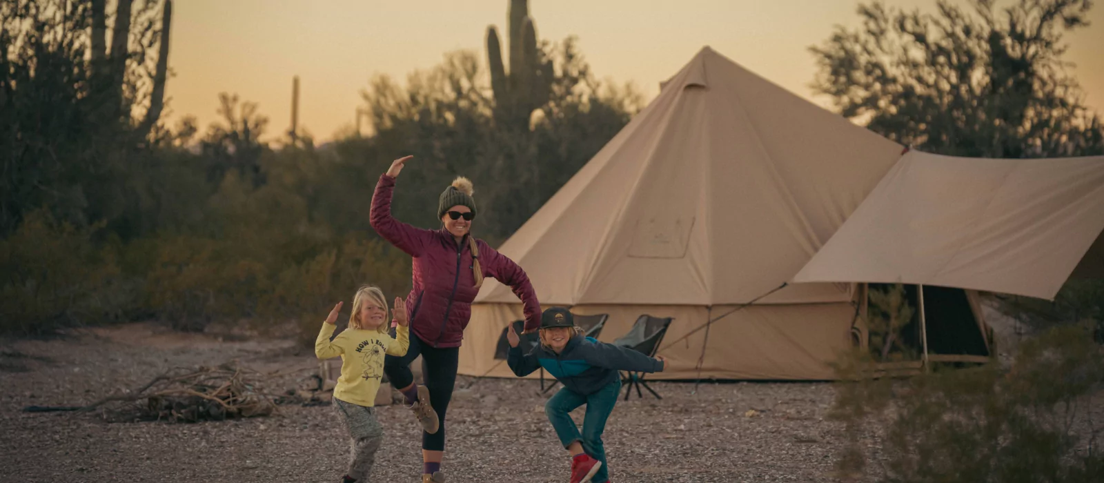 family enjoying camping with canvas tent