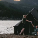 friends enjoying bell tent camping near the lake and mountains