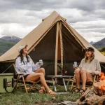 friends enjoying campfire games on camping adventure