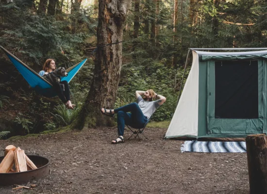 couple sharing campfire stories on camping in forest