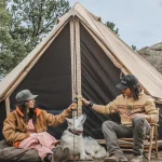 friends enjoying camping with dog