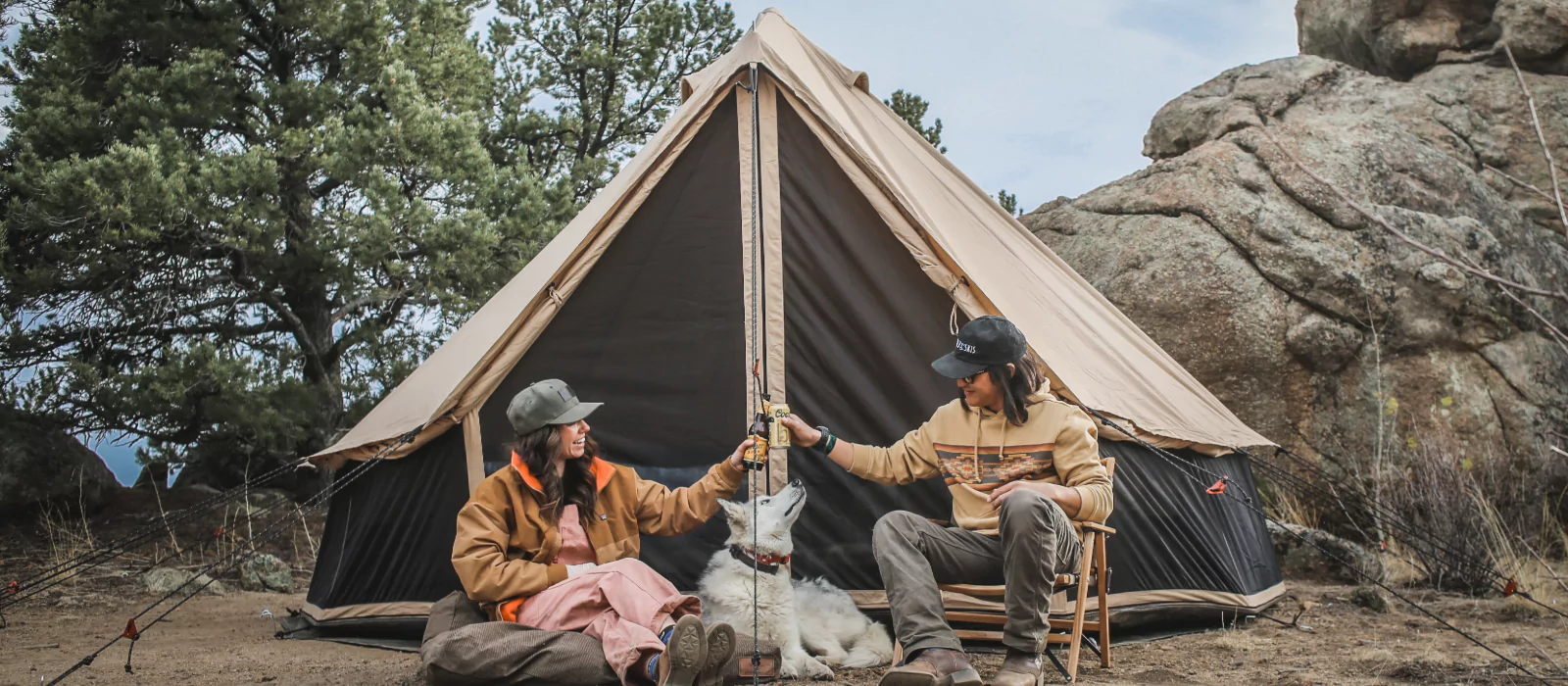 friends enjoying camping with dog