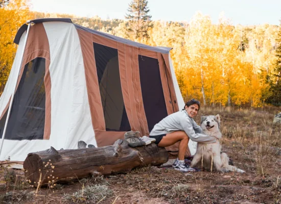 girl enjoying outdoors with dog using cabin tent