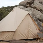 yurt tent setup around rocky mountains for traditional yurt camping