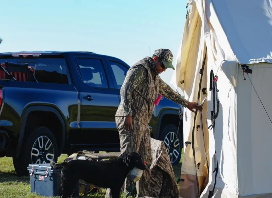 hunting camp with wall tent and dog