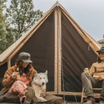 friends enjoying yurt tent camping with dog