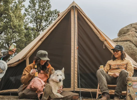 friends enjoying yurt tent camping with dog