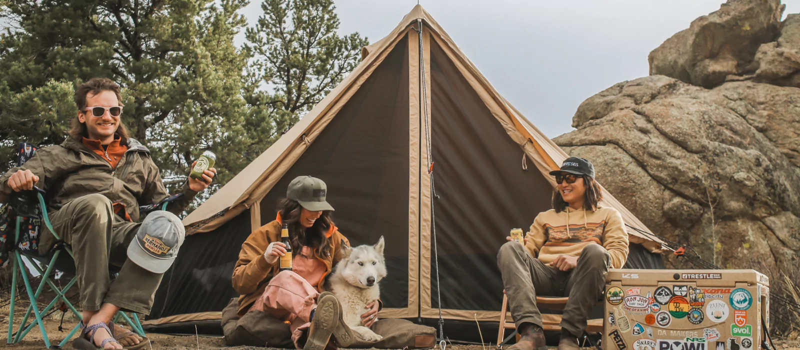 friends enjoying yurt tent camping with dog