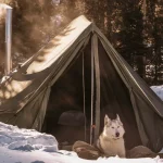 do enjoying snow with canvas tent with wood burning stove behind