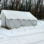canvas wall tent in a snowy winter landscape