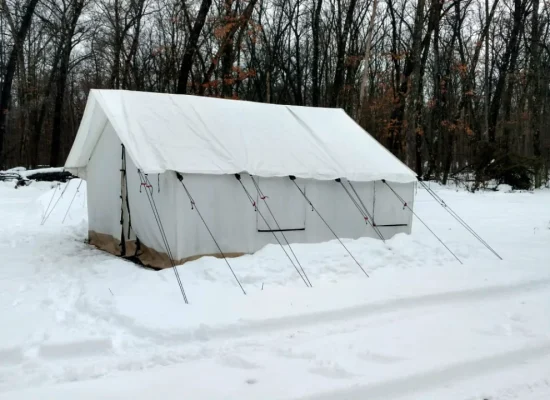 canvas wall tent in a snowy winter landscape