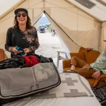 wo people enjoying comfort inside a spacious glamping tent
