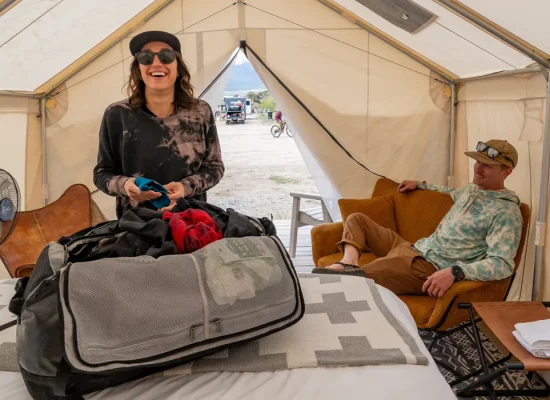 wo people enjoying comfort inside a spacious glamping tent