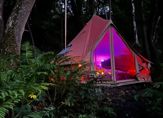 bell-tent-setup-in-forest-with-lightning-for-glamping