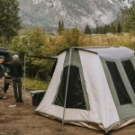 friends enjoying outdoors with cabin tent setup in nature for perfect outdoors
