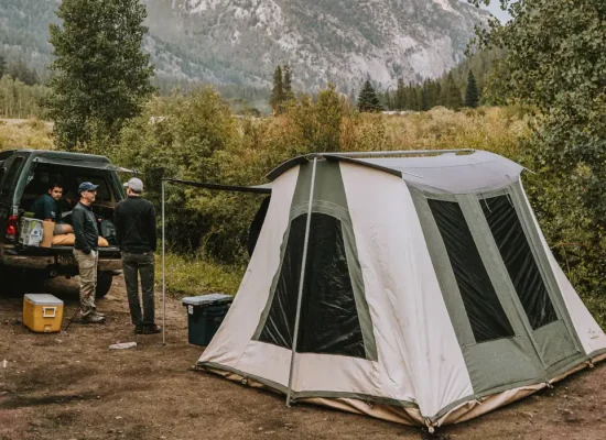 friends enjoying outdoors with cabin tent setup in nature for perfect outdoors