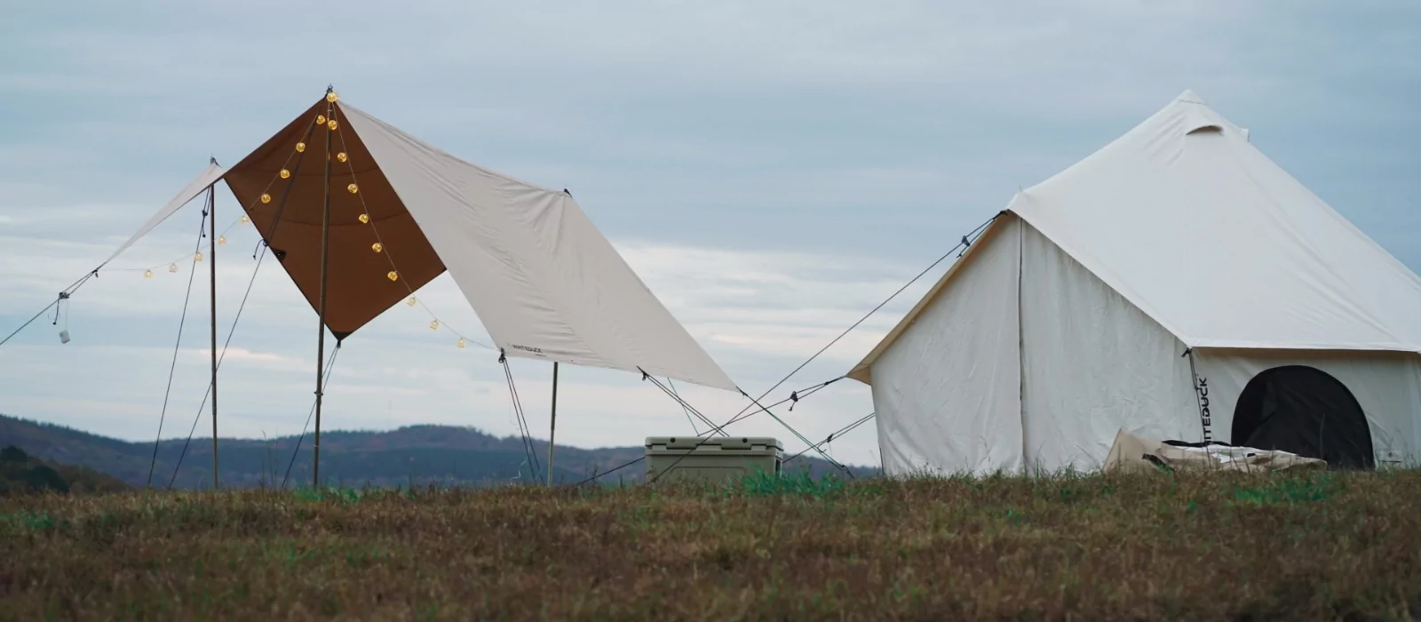 diy shade created beside the tent on beautiful landscape
