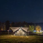camping tent setup with lightening at night on campground