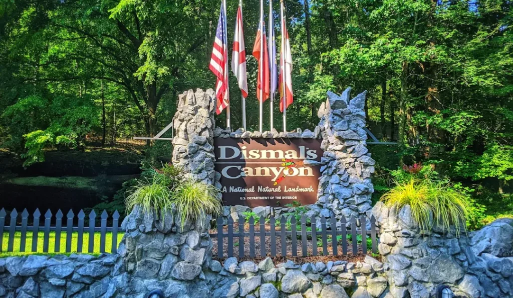 dismals canyon campground with american flags | credit: Dismals Canyon GMB