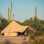 bell tent setup in desert during summer camping