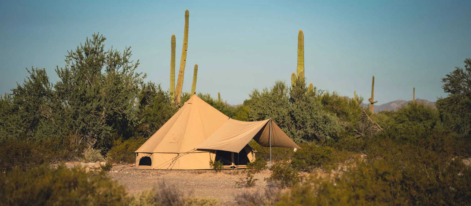 bell tent setup in desert during summer camping