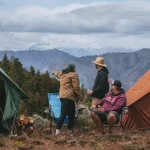 Friends camping with canvas tents in the mountains