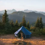 Canvas tent set up in the mountains during summer camping trip