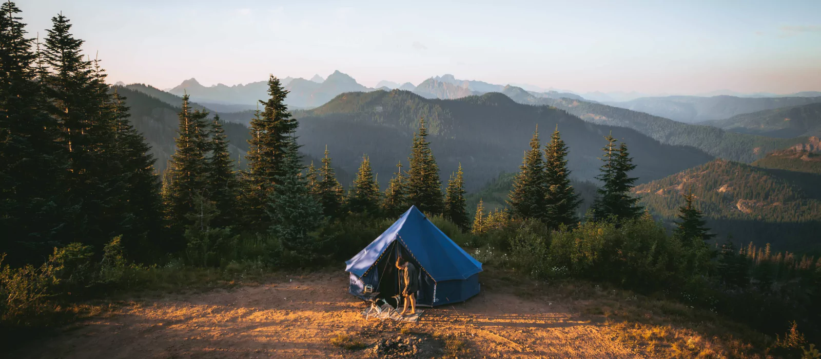Canvas tent set up in the mountains during summer camping trip