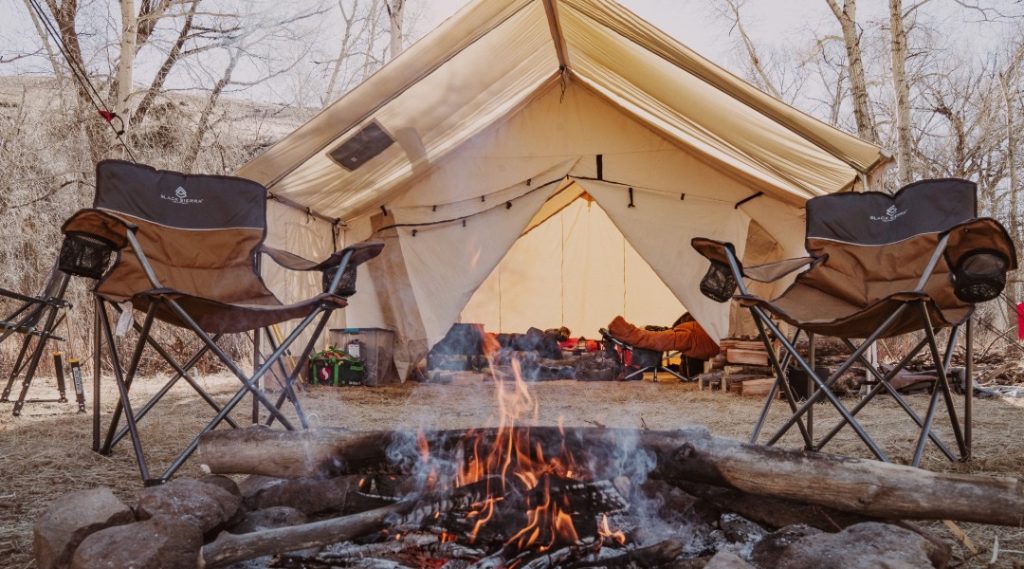 Campfire setup around canvas wall tent