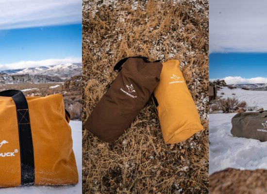 WhiteDuck Hoplite Series bags displayed outdoors in winter and fall conditions, including yellow, brown, and olive duffel-style carry bags shown on snow and dry grass.