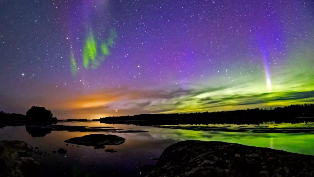 Northern Lights reflecting over a lake in Voyageurs National Park, Minnesota