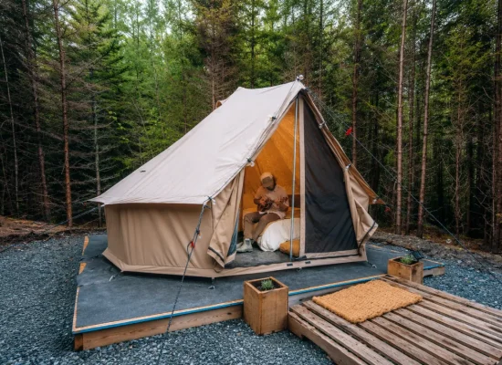 Solo glamping in a canvas tent surrounded by a peaceful forest