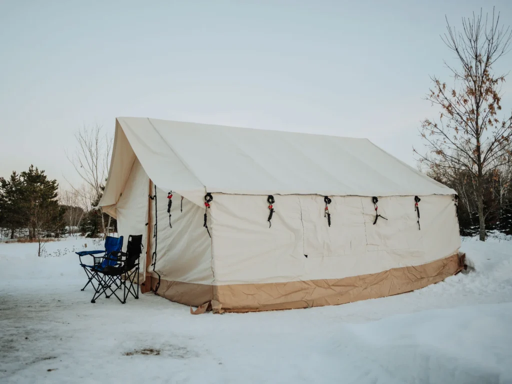 alpha wall tent pitched on snowy campground