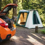 Cabin tent setup for solo camping with a car and dog in the forest