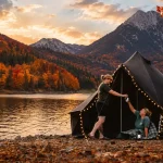 Fall foliage glamping with a canvas tent beside a mountain lake surrounded by colorful autumn trees