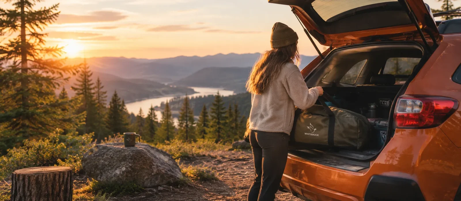 Jess packing camping gear into an SUV at sunset after a solo camping trip