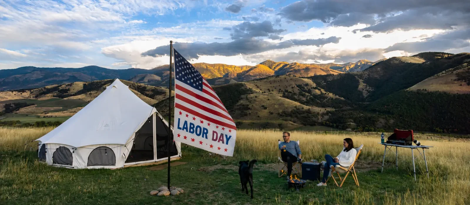 Labor Day camping trip with a white bell tent and American flag in a mountain campsite