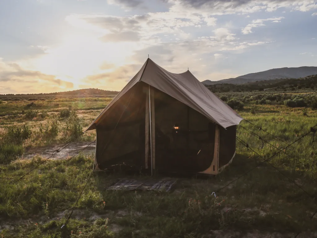 rover scout tent setup in plain green field